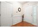 Welcoming foyer with hardwood floors and white trim, featuring a coat closet and entry door at 5428 Colonial Garden Dr, Huntersville, NC 28078