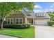 Charming home with a well-manicured lawn, tidy shrubbery, and an attached two-car garage at 5428 Colonial Garden Dr, Huntersville, NC 28078