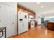 Functional kitchen area with wooden cabinets, white appliances, and adjacent dining area for convenient living and entertaining at 5428 Colonial Garden Dr, Huntersville, NC 28078