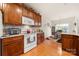 Well-equipped kitchen with wooden cabinetry and an island, seamlessly connecting to a dining area for easy meal serving at 5428 Colonial Garden Dr, Huntersville, NC 28078