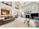 Open-concept living room with a fireplace, adjoined with a kitchen and dining area for seamless living at 5428 Colonial Garden Dr, Huntersville, NC 28078