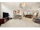 Open-concept living room featuring neutral color palette and vaulted ceilings, perfect for comfortable living and entertaining at 5428 Colonial Garden Dr, Huntersville, NC 28078