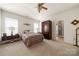 Serene main bedroom boasts natural light, a neutral palette, and an ensuite bathroom for ultimate comfort and privacy at 5428 Colonial Garden Dr, Huntersville, NC 28078