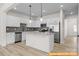 Modern kitchen featuring white cabinetry, stainless steel appliances, and granite countertops at 6009 Jasmine Branch Rd, Charlotte, NC 28216