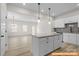 Bright, open kitchen featuring a center island and seamless flow to the living area at 6009 Jasmine Branch Rd, Charlotte, NC 28216