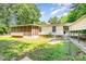 Backyard featuring a fenced-in yard, screened-in porch, and covered carport at 611 W Robinson St, Dallas, NC 28034