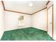 This bedroom features a window letting in natural light and wall-to-wall green carpeting at 611 W Robinson St, Dallas, NC 28034
