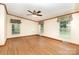 Spacious bedroom with hardwood floors, ceiling fan and three windows that provide plenty of natural light at 611 W Robinson St, Dallas, NC 28034