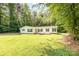Charming home with well-manicured lawn and curb appeal enhanced by green shutters at 611 W Robinson St, Dallas, NC 28034