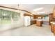 Bright kitchen featuring oak cabinets, white appliances, an island, and large windows at 611 W Robinson St, Dallas, NC 28034