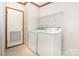 Functional laundry room featuring a washer and dryer, shelving, and ample space for storage at 611 W Robinson St, Dallas, NC 28034