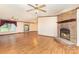 The living room highlights a brick fireplace and hardwood floors, blending comfort and style for everyday living at 611 W Robinson St, Dallas, NC 28034