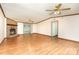 A bright living room with hardwood floors boasts a cozy stone fireplace and natural light from sliding glass doors at 611 W Robinson St, Dallas, NC 28034