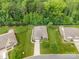 Aerial view of house with lush landscaping, a large driveway, and mature trees surrounding the property at 8737 Mullis Forest Ct, Mint Hill, NC 28227