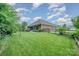 Spacious, green backyard featuring a well-maintained lawn and wood fence that surrounds the property at 8737 Mullis Forest Ct, Mint Hill, NC 28227