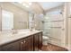 Bathroom featuring double sinks, a glass-enclosed shower, and modern fixtures at 8737 Mullis Forest Ct, Mint Hill, NC 28227