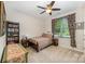 Cozy bedroom with a ceiling fan, two side tables, a book shelf and colorful window treatments at 8737 Mullis Forest Ct, Mint Hill, NC 28227