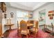 Cozy dining room featuring a chandelier, round table, and large window for natural light at 8737 Mullis Forest Ct, Mint Hill, NC 28227