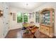Bright dining area featuring hardwood floors, natural lighting, and classic china cabinet at 8737 Mullis Forest Ct, Mint Hill, NC 28227