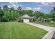 Well-maintained home with lush lawn, mature trees, and long driveway leading to a two-car garage at 8737 Mullis Forest Ct, Mint Hill, NC 28227