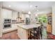 Modern kitchen with granite countertops, stainless steel appliances, and center island with seating at 8737 Mullis Forest Ct, Mint Hill, NC 28227