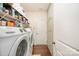 Laundry room equipped with washer, dryer, storage cabinets, and shelving at 8737 Mullis Forest Ct, Mint Hill, NC 28227