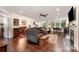 Spacious open-concept living room featuring hardwood floors, fireplace, and ample natural light at 8737 Mullis Forest Ct, Mint Hill, NC 28227