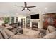 Inviting living room boasts a fireplace, ceiling fan, hardwood floors, and comfortable seating at 8737 Mullis Forest Ct, Mint Hill, NC 28227