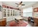 Bright office featuring built-in bookshelves, a ceiling fan, and a window offering natural light at 8737 Mullis Forest Ct, Mint Hill, NC 28227