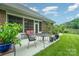 Enjoy this outdoor patio space with a wrought iron dining set and lovely views of the green backyard at 8737 Mullis Forest Ct, Mint Hill, NC 28227