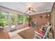 Enclosed sunroom with brick walls, a ceiling fan, and plenty of windows allowing natural light at 8737 Mullis Forest Ct, Mint Hill, NC 28227