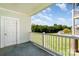 Balcony featuring a view of a grassy area, trees, a swimming pool, and the exterior of the building at 8969 Meadow Vista Rd, Charlotte, NC 28213