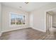 Cozy room boasts hardwood floors, a large window with a view of the neighborhood, and a neutral color scheme at 8969 Meadow Vista Rd, Charlotte, NC 28213