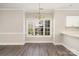 Dining room featuring decorative chandelier and hardwood style floors under a large window at 8969 Meadow Vista Rd, Charlotte, NC 28213