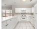 Bright kitchen with white cabinetry, appliances, and tiled floors at 8969 Meadow Vista Rd, Charlotte, NC 28213