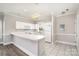Well-lit kitchen with white cabinets, appliances, and a bar counter for seating at 8969 Meadow Vista Rd, Charlotte, NC 28213