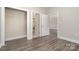 Laundry closet with washer, dryer, open door and hardwood style floors at 8969 Meadow Vista Rd, Charlotte, NC 28213