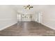 Spacious living room with hardwood floors, ceiling fan, and direct access to a kitchen area at 8969 Meadow Vista Rd, Charlotte, NC 28213