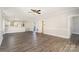 Bright living room featuring modern ceiling fan, hardwood floors, and open access to the kitchen at 8969 Meadow Vista Rd, Charlotte, NC 28213
