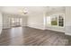 Open living room with sliding glass doors leading to outdoor space and hardwood style floors at 8969 Meadow Vista Rd, Charlotte, NC 28213