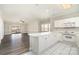 Open floor plan with kitchen island flowing into a spacious living room with a sliding door to balcony at 8969 Meadow Vista Rd, Charlotte, NC 28213