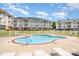Community pool area with multiple lounge chairs, perfect for relaxing on a sunny day at 8969 Meadow Vista Rd, Charlotte, NC 28213