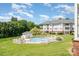 Inviting community pool area with lounge chairs and well-maintained landscaping, surrounded by mature trees at 8969 Meadow Vista Rd, Charlotte, NC 28213
