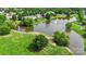 Aerial view of a pond with a fountain, surrounded by lush greenery and residential homes at 9008 Magna Ln, Indian Trail, NC 28079