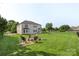 Large, fenced backyard with lush grass, a fire pit, and a play area at 9008 Magna Ln, Indian Trail, NC 28079