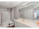 Functional bathroom with a shower-tub combo, spacious vanity, and practical tile flooring at 9008 Magna Ln, Indian Trail, NC 28079