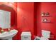 Vibrant half bathroom with a modern sink, stylish mirror, and open shelves at 9008 Magna Ln, Indian Trail, NC 28079