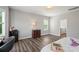 Bedroom featuring a desk area with wood look floors, neutral wall color and natural light at 9008 Magna Ln, Indian Trail, NC 28079