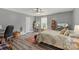 Stylish bedroom with a decorative rug, contemporary decor, and a view of the TV at 9008 Magna Ln, Indian Trail, NC 28079