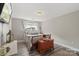 Comfortable bedroom featuring stylish furnishings, a TV, and a bright window for natural light at 9008 Magna Ln, Indian Trail, NC 28079